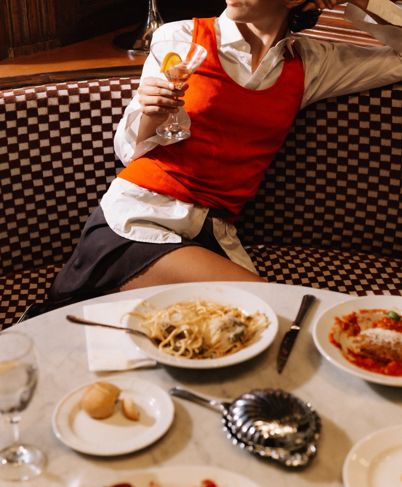 Cocktail with a citrus garnish at a restaurant table